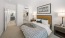 a bedroom with a bed and a mirror